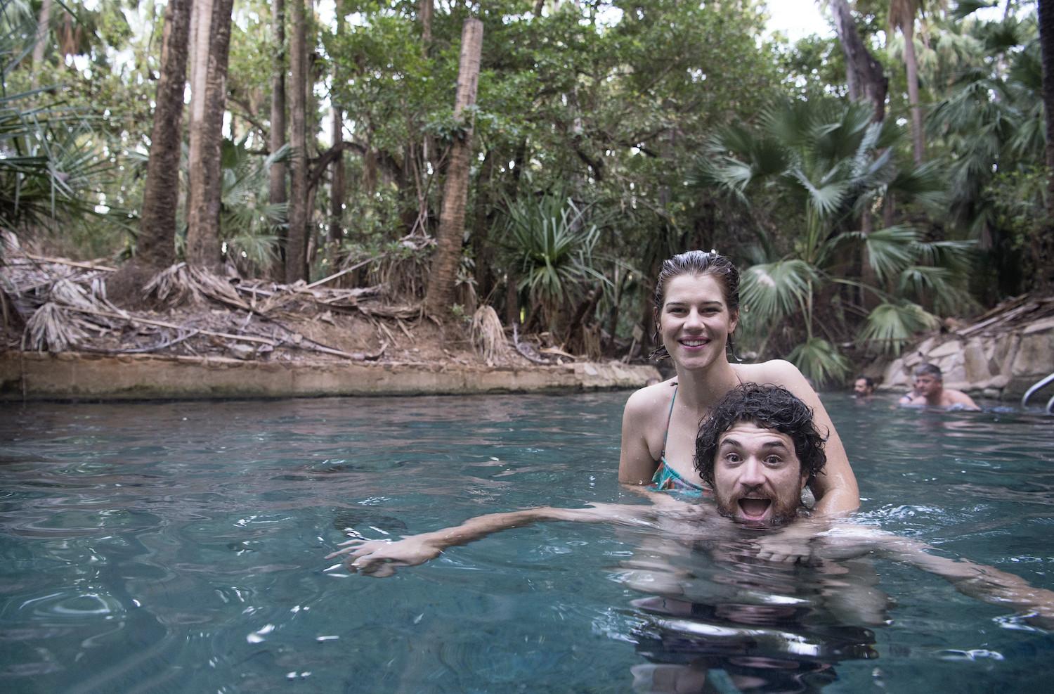 Young couple in the waters of Mataranka Thermal Pool, Elsey National Park