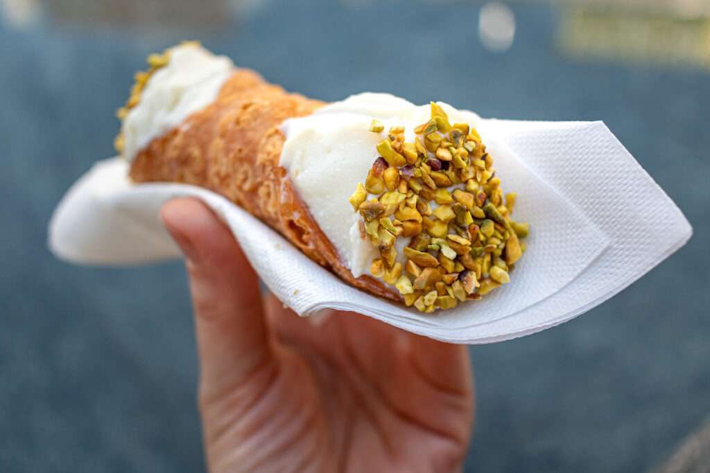 Close up of a fresh Italian Cannoli, held by hand on tour with Exodus Travels