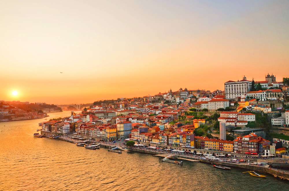 Magnificent sunset over the Porto city center and the Douro river, Portugal. Dom Luis I Bridge is a popular tourist spot as it offers such a beautiful view over the area.